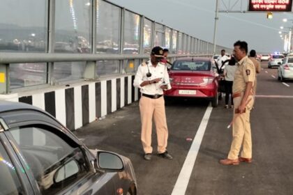 Mumbai traffic policemen penalise violators on the sea bridge on Sunday. Express
